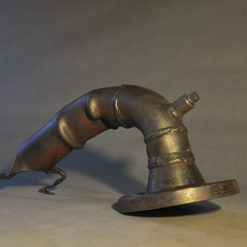 A sculpted pipe with legs pushing hard